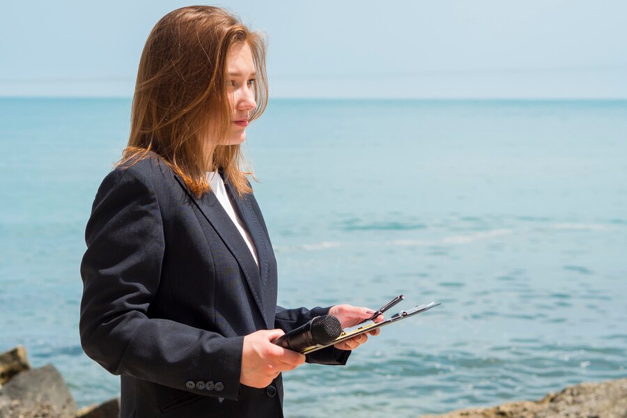 a woman holding a clipboard and microphone